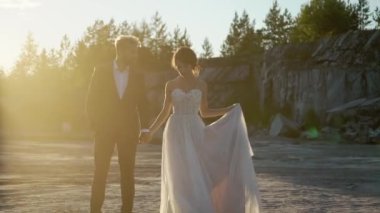 Gün batımında yürüyen genç güzel Çift