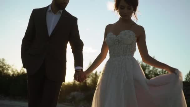 Young lovely couple walking at sunset — Stock Video