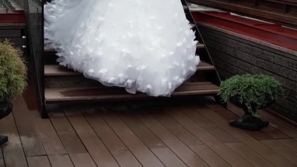 Bruden går på terrassen vid regnigt väder — Stockvideo