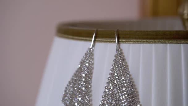 Beautiful earrings on lamp — Stock Video