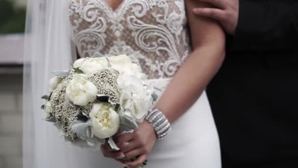 Неузнаваемые невеста и жених обнимаются — стоковое видео