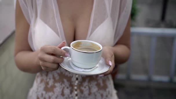 Young woman in lingerie with cup of coffee — Stock Video