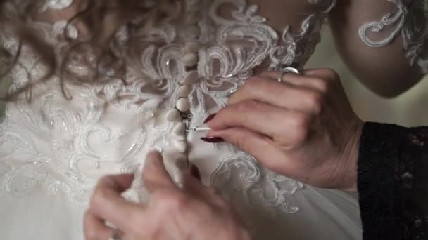 Elderly woman buttoning wedding dress — Stock Video