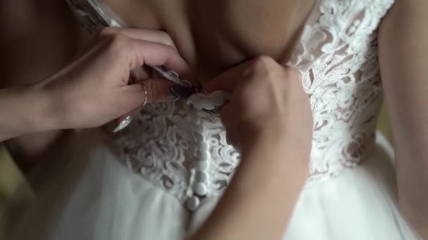 Bridesmaid helps wearing wedding dress — Stock Video