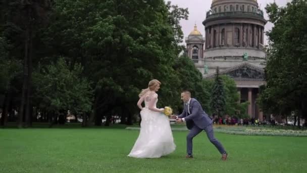 Braut und Bräutigam tanzen im Park — Stockvideo