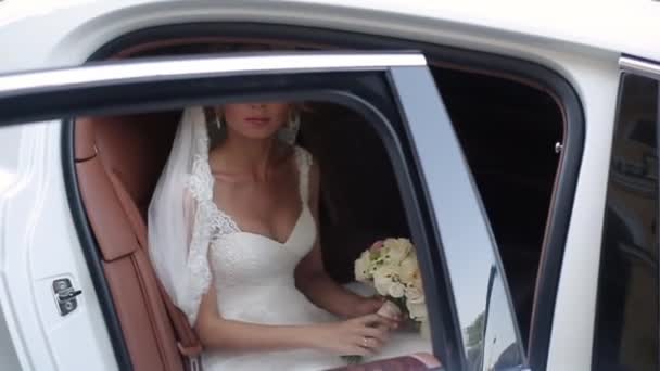 Jonge blonde bruid zitten in auto — Stockvideo