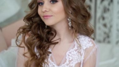 Beyaz iç çamaşırlarıyla poz parfüm olan güzel kadın