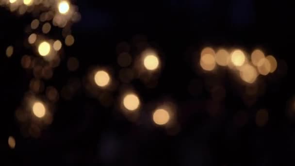 Abstract blur. People light sparklers on the street. Celebration of New year, Christmas or other holiday. Romantic evening or night with lights — Stock Video