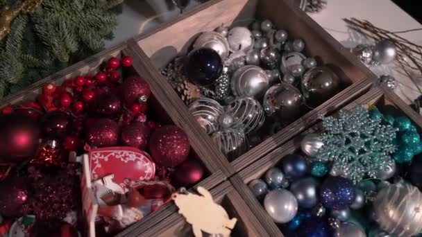 Preparation for the celebration of Christmas and New year. Girls decorate Christmas tree with balls and toys. Festive mood — Stock Video