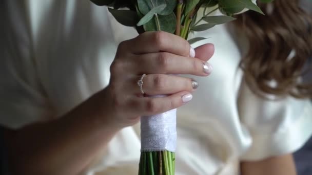 Young beautiful girl in lingerie or Bathrobe with flowers. Bridal bouquet, wedding morning. Woman posing — Stock Video