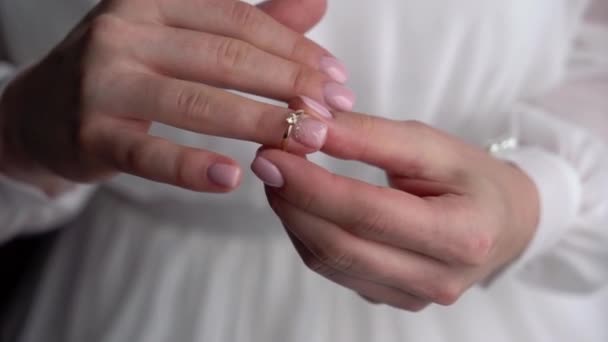 Young woman put on her finger jewelry ring with diamond. Luxury expensive proposal ring. Bride in wedding day — Stock Video