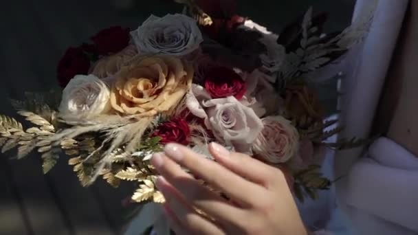 Young beautiful girl in lingerie or Bathrobe with flowers. Bridal bouquet, wedding morning. Woman posing — Stock Video
