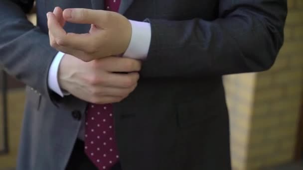 Young man put on jacket. Dressing for celebration event, business meeting or wedding — Stock Video