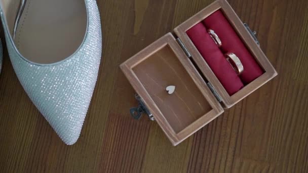 Wedding rings and bridal shoes. Pair of marriage symbols. Love of bride and groom becoming wife and husband. Matrimony symbol. — Stock Video