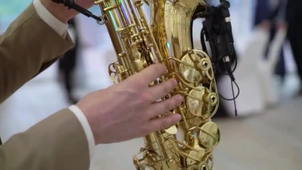 Saxophonist musician playing saxophone or sax at the concert or party — Stock Video