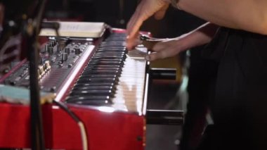 Elektronik klavye sentezleyici piyano çalan müzisyen. Konser sahnesinde müzik çalan bir grup.