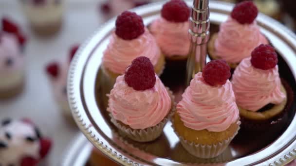 Pink cupcakes with raspberry. Sweets at the birthday party — Stock Video