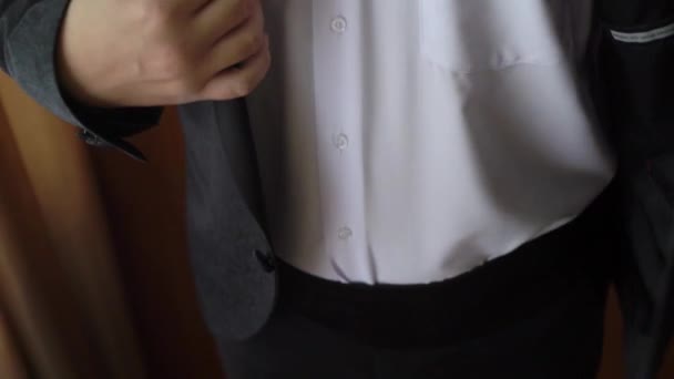 El joven se puso la chaqueta. Vestirse para la celebración de eventos, reuniones de negocios o bodas — Vídeo de stock