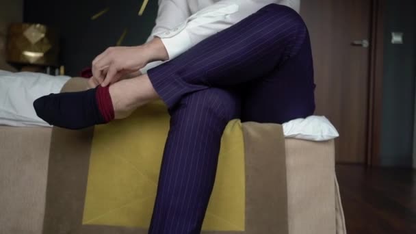 Young man put on socks. Dressing for celebration event, business meeting or wedding — Stock Video