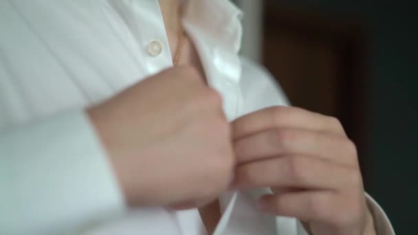 Young man put on classic white shirt. Groom dressing suit. Businessman or office worker preparing in the morning — Stock Video