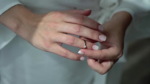 Young woman put on her finger jewelry ring with diamond. Luxury expensive proposal ring. Bride in wedding day — Stock Video