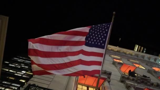 American USA flag at night. Street of New York city — Stock Video