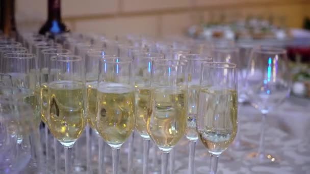 Glass with champagne or white sparkling wine at the party — Stock Video
