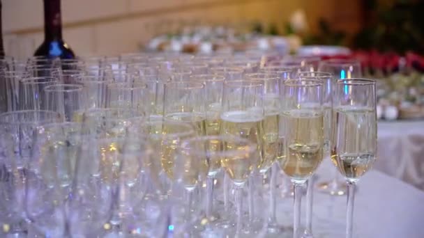 Glass with champagne or white sparkling wine at the party — Stock Video