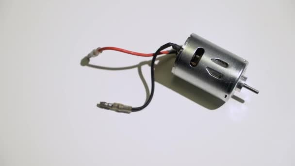 Small electric motor engine at white background — Stock Video
