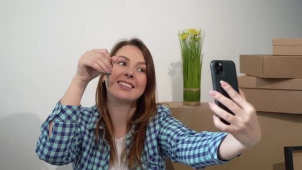 Giovane donna che si fa selfie sul cellulare. Trasferire nuovo appartamento a casa, scatole — Video Stock