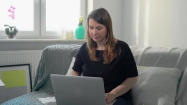 Evde bilgisayarla uzaktan çalışan genç bir kadın. Covid-19 Coronavirüs