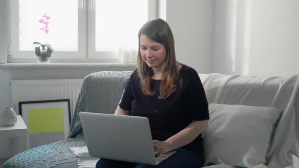 Young woman working remotely at home with computer laptop. Covid-19 coronavirus — Stock Video