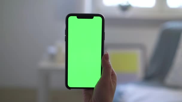 Smartphone with green screen display chromakey, woman holding in hand and using — Stock Video
