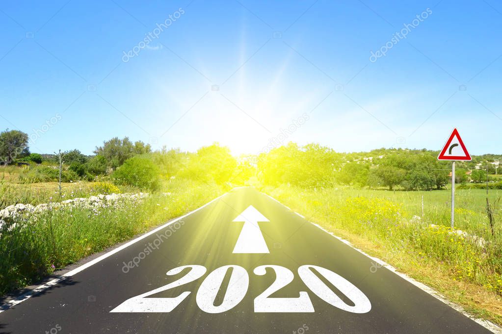 Highway with written 2020 with arrow and sun, for Christmas and New Year greetings