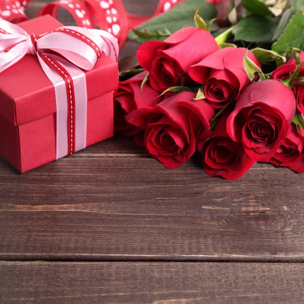 Fundo dos namorados de caixa de presente e rosas vermelhas em madeira. Espaço fo — Fotografia de Stock