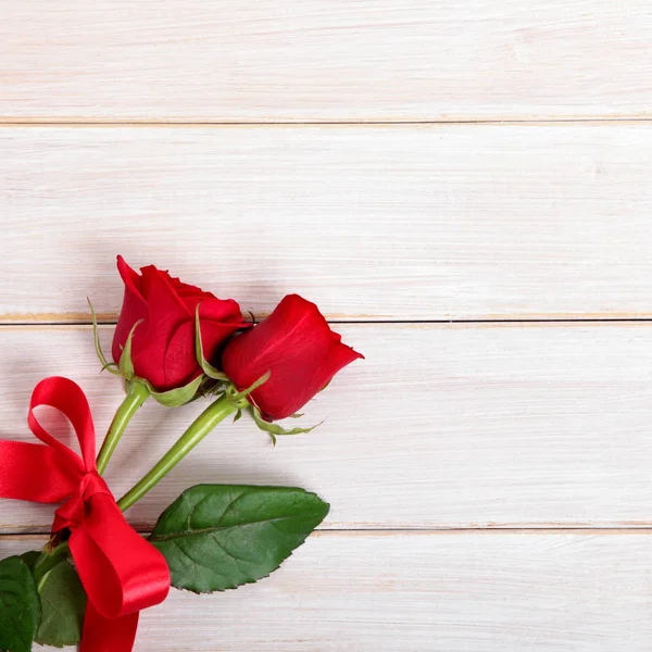 Valentine background of  red roses on  white wood. Space for cop Stock Photo