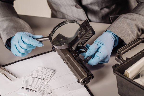 Detective through a magnifying glass looking at a evidence 