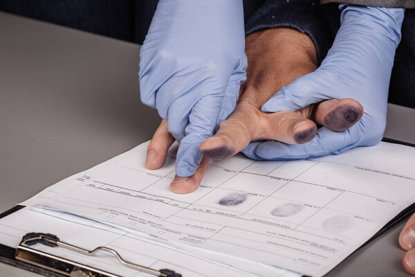 police takes fingerprints of a criminal 
