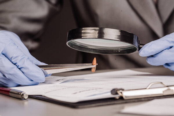 Expert with magnifying glass