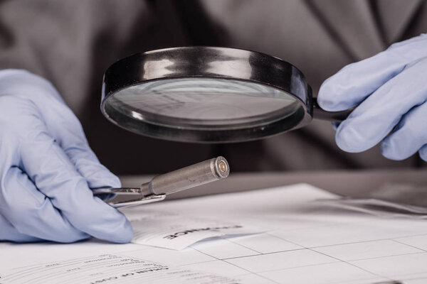 Expert with magnifying glass