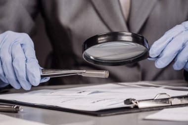 Kriminoloji uzmanı olan büyüteç aracılığıyla 