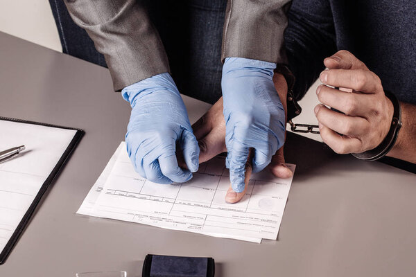 police takes fingerprints of a criminal 