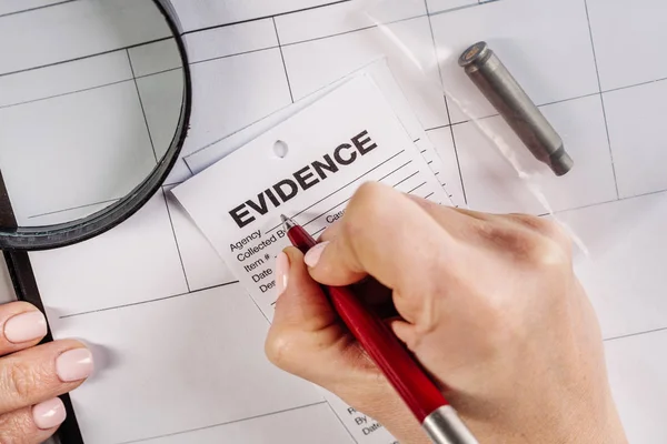 Detective  expert writes data into — Stock Photo, Image