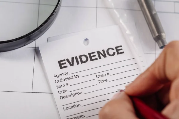 Detective  expert writes data into — Stock Photo, Image