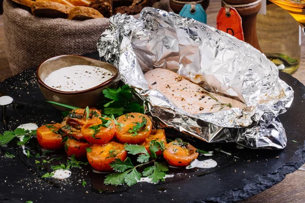 Baked fish in foil on table — Stock Photo, Image