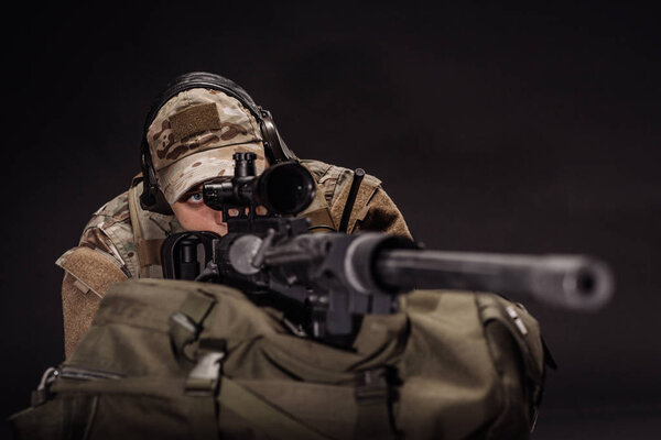 private military contracto with his sniper rifle at night. war, army, weapon, technology and people concept