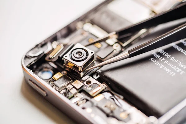 Repairing Damaged Smart Phone in service center. closeup