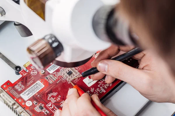 woman repairing computer hardware in service center