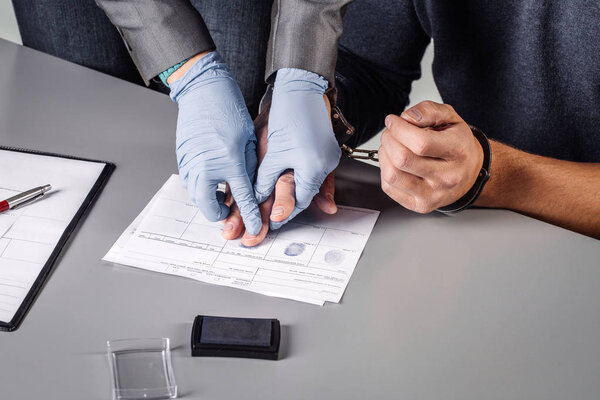 police takes fingerprints of a criminal