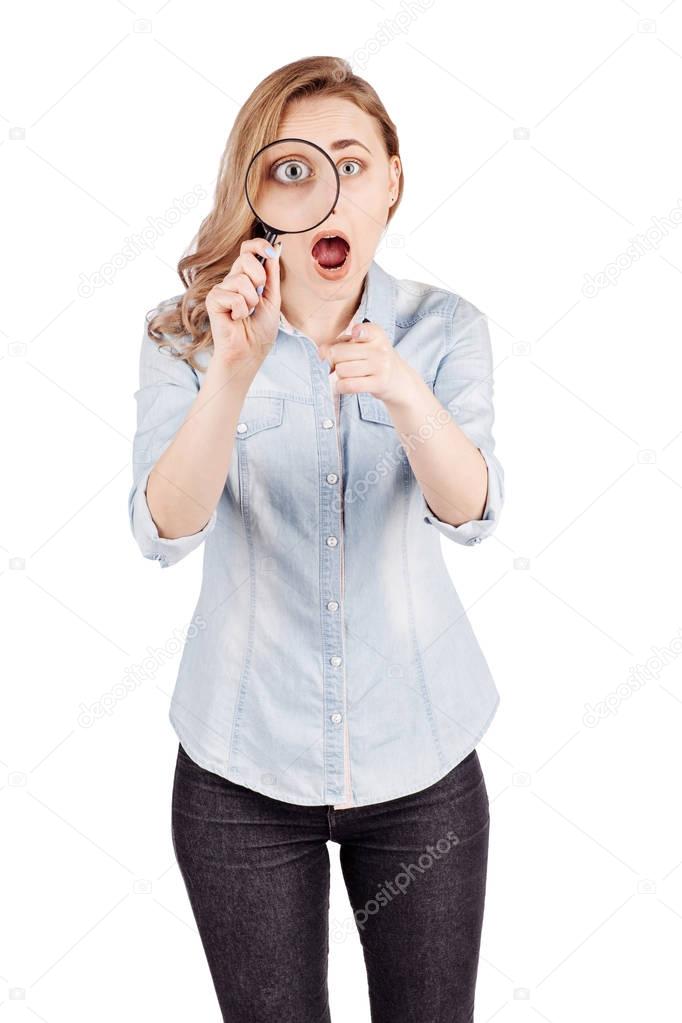 woman looking through a magnifying glass